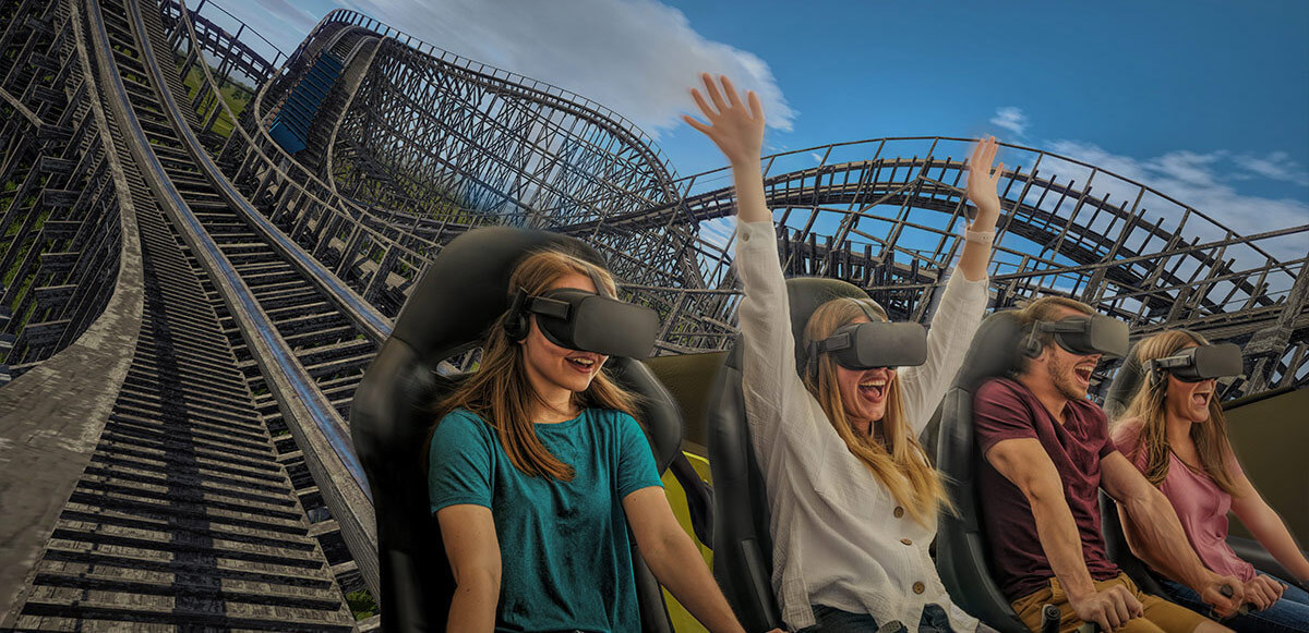 Row of laughing and smiling friends experiencing VR InMotion coaster.