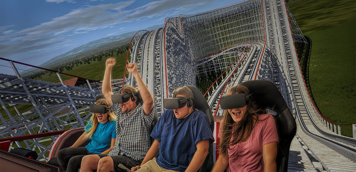 Row of laughing and smiling friends, some with their hands up, experiencing VR InMotion coaster.